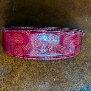 Coach Signature Red Eyeglass Pouch with zipper closure.